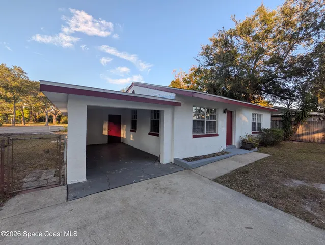 a view of a house with a yard and garage