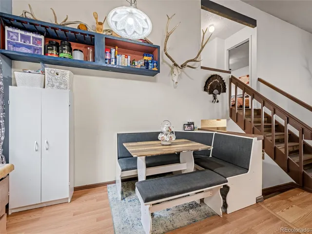 a view of a room with furniture and wooden floor