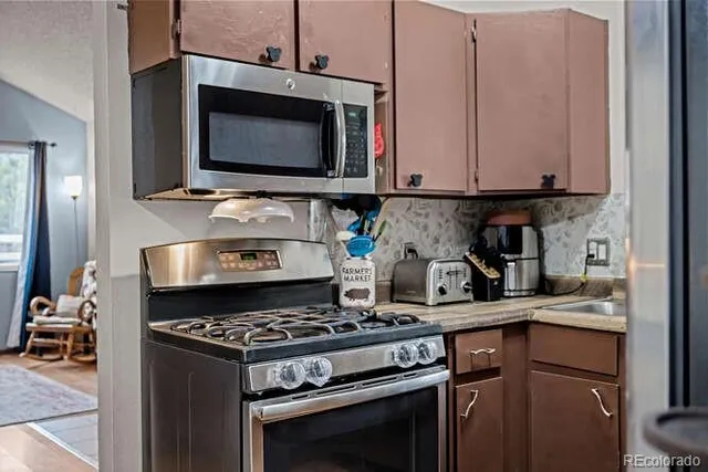 a kitchen with a stove and a microwave