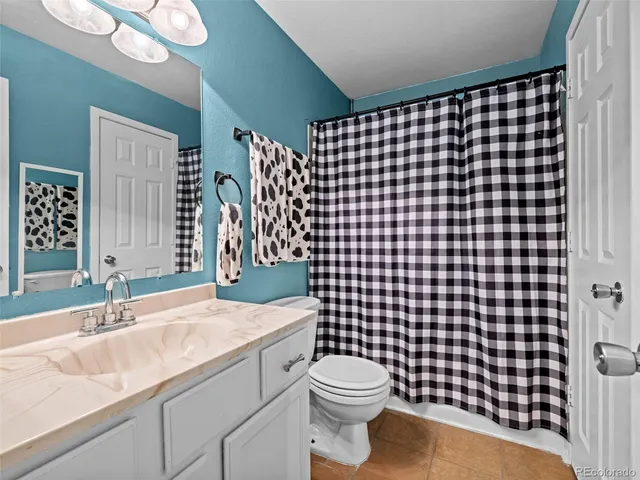 a bathroom with a sink vanity mirror and toilet