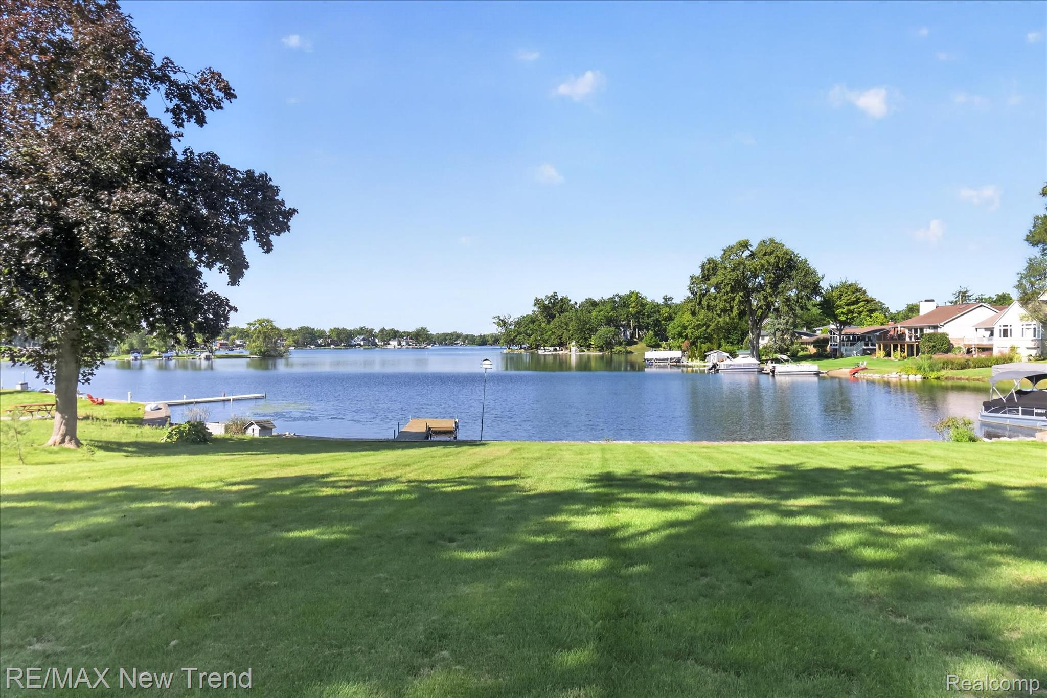 2529 South Commerce Road Walled Lake, MI 48390 - Photo 8 of 66 Expansive waterfront property featuring a manicured lawn, direct lake access, and a private dock