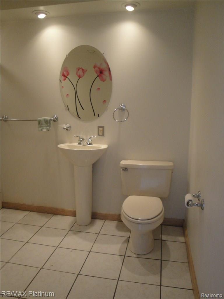 4250 Crandall Road Howell, MI 48855 - Photo 41 of 57 Ceramic flooring, pedestal sink and recessed lighting