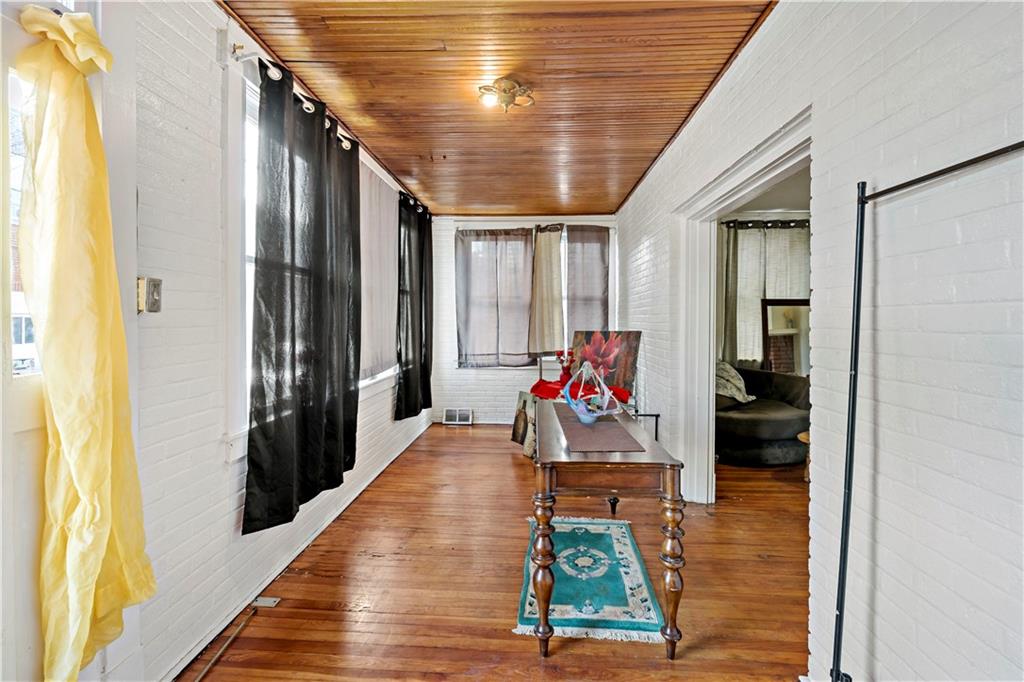 1210 Holmes Street McKees Rocks, PA 15136 - Photo 15 of 44 a living room with furniture and a wooden floor