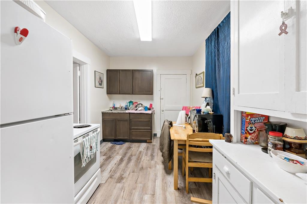 1210 Holmes Street McKees Rocks, PA 15136 - Photo 17 of 44 a kitchen with a refrigerator and a stove top oven