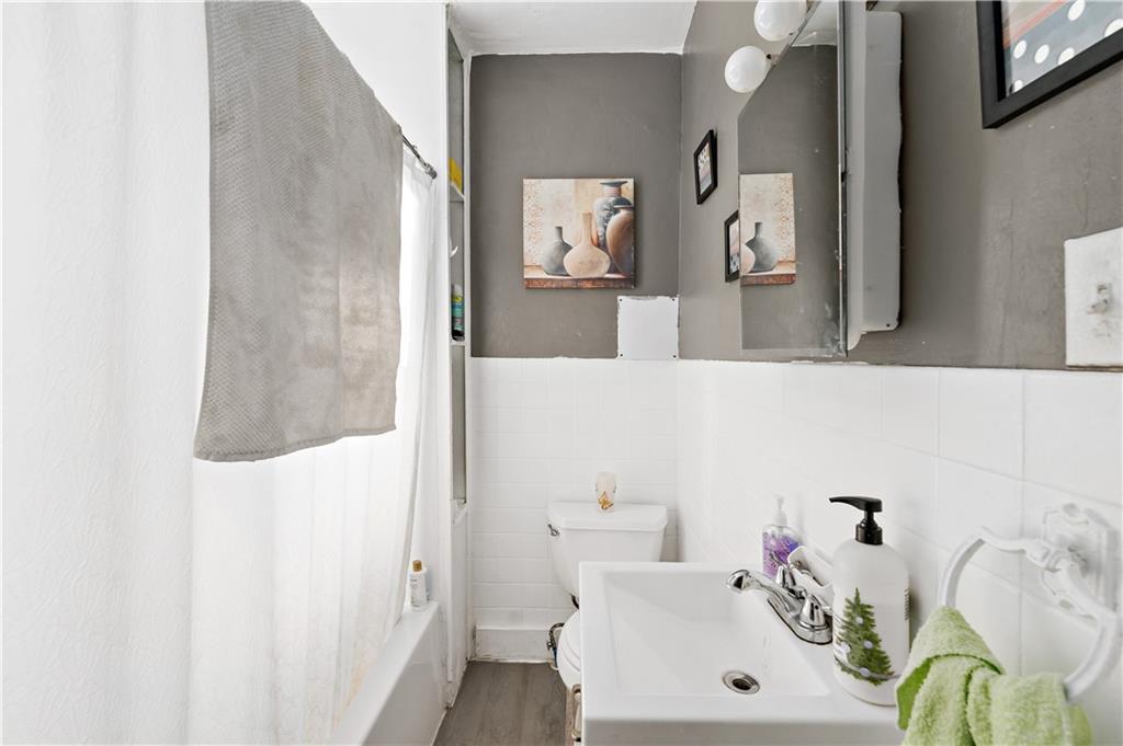 1210 Holmes Street McKees Rocks, PA 15136 - Photo 20 of 44 a bathroom with a sink and a mirror
