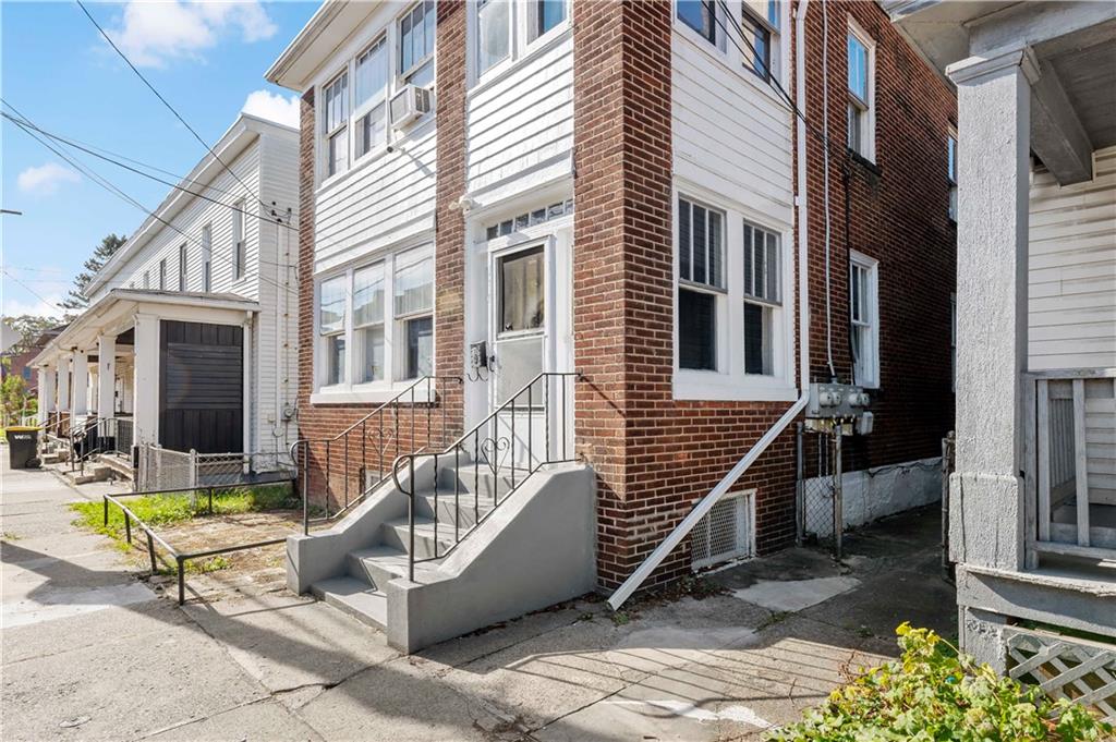 1210 Holmes Street McKees Rocks, PA 15136 - Photo 2 of 44 a view of a building with many windows and furniture