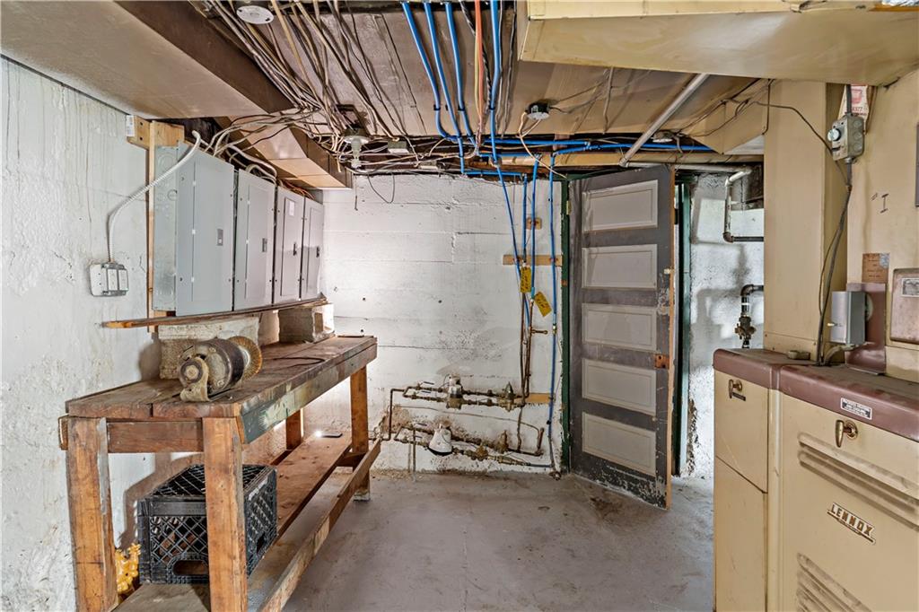 1210 Holmes Street McKees Rocks, PA 15136 - Photo 22 of 44 a utility room with stainless steel appliances kitchen island granite countertop a sink and a refrigerator