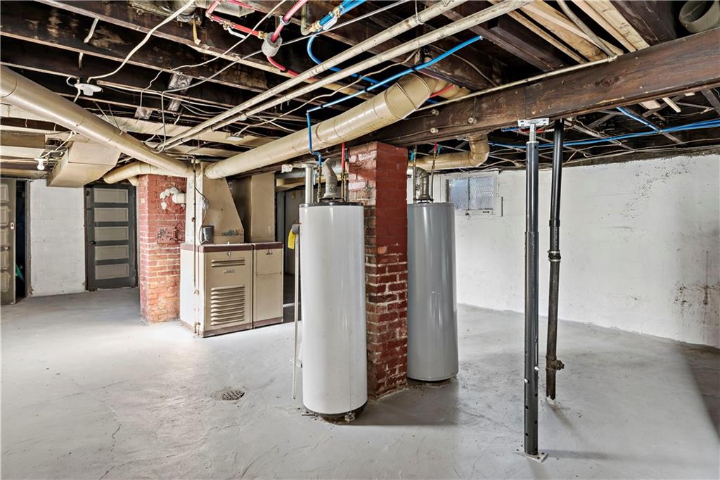 1210 Holmes Street McKees Rocks, PA 15136 - Photo 24 of 44 a view of water heater room with staircase