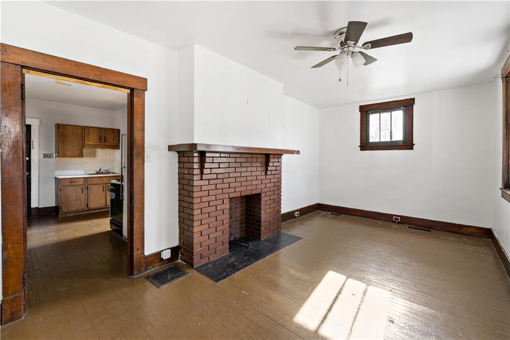 1210 Holmes Street McKees Rocks, PA 15136 - Photo 4 of 44 a view of a livingroom with a fireplace and window