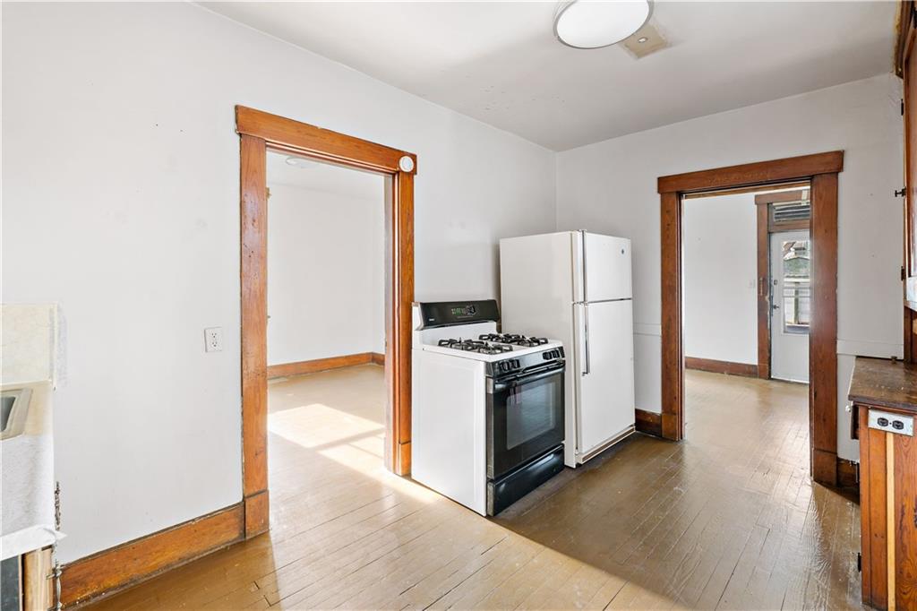 1210 Holmes Street McKees Rocks, PA 15136 - Photo 8 of 44 a kitchen with a refrigerator and a stove top oven