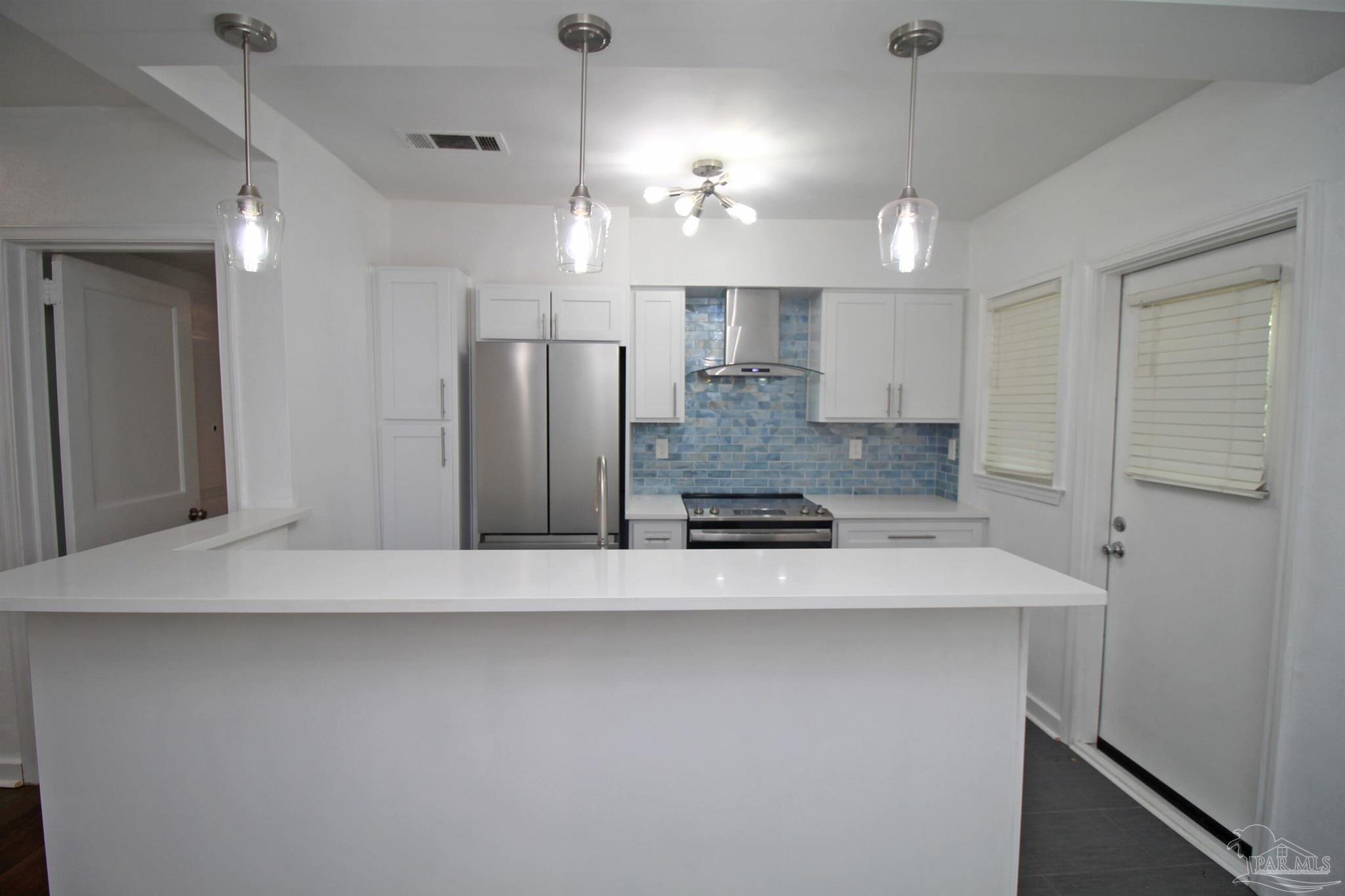 315 Flannan Road Pensacola, FL 32507 - Photo 10 of 17 a large kitchen with cabinets and stainless steel appliances