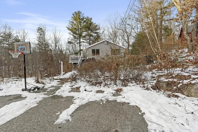 a view of a house with a yard covered in snow