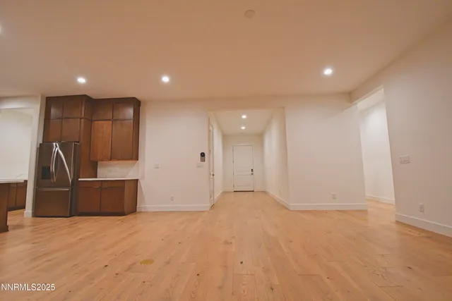 a large kitchen with stainless steel appliances a large counter top a stove and a refrigerator