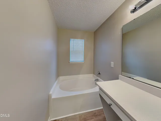 a bathroom with a bathtub and shower