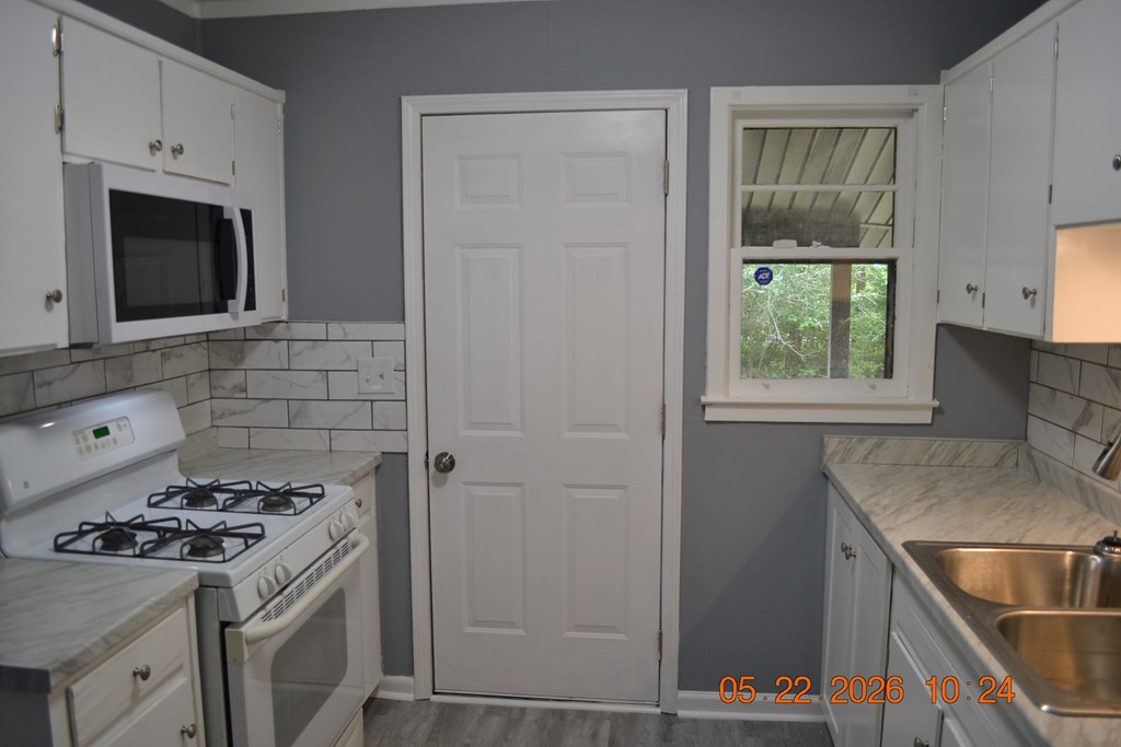 5552 Valleybrook Road Columbus, GA 31907 - Photo 7 of 27 a kitchen with a stove and a sink