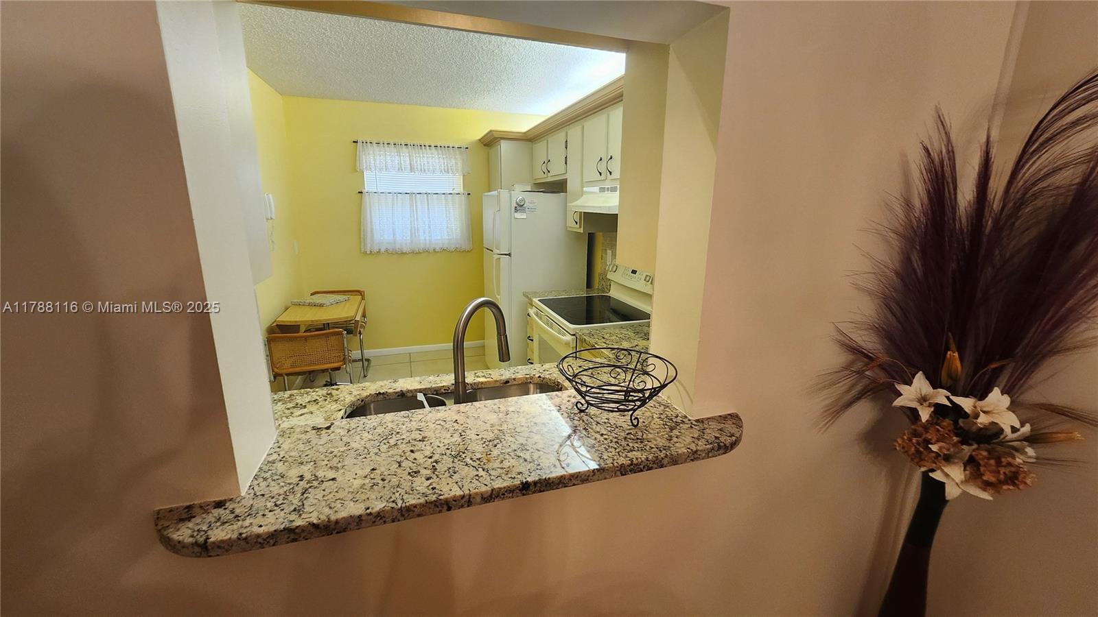 2955 Southwest 22nd Avenue, Unit 1040 Delray Beach, FL 33445 - Photo 12 of 27 a bathroom with a granite countertop sink a mirror and a shower