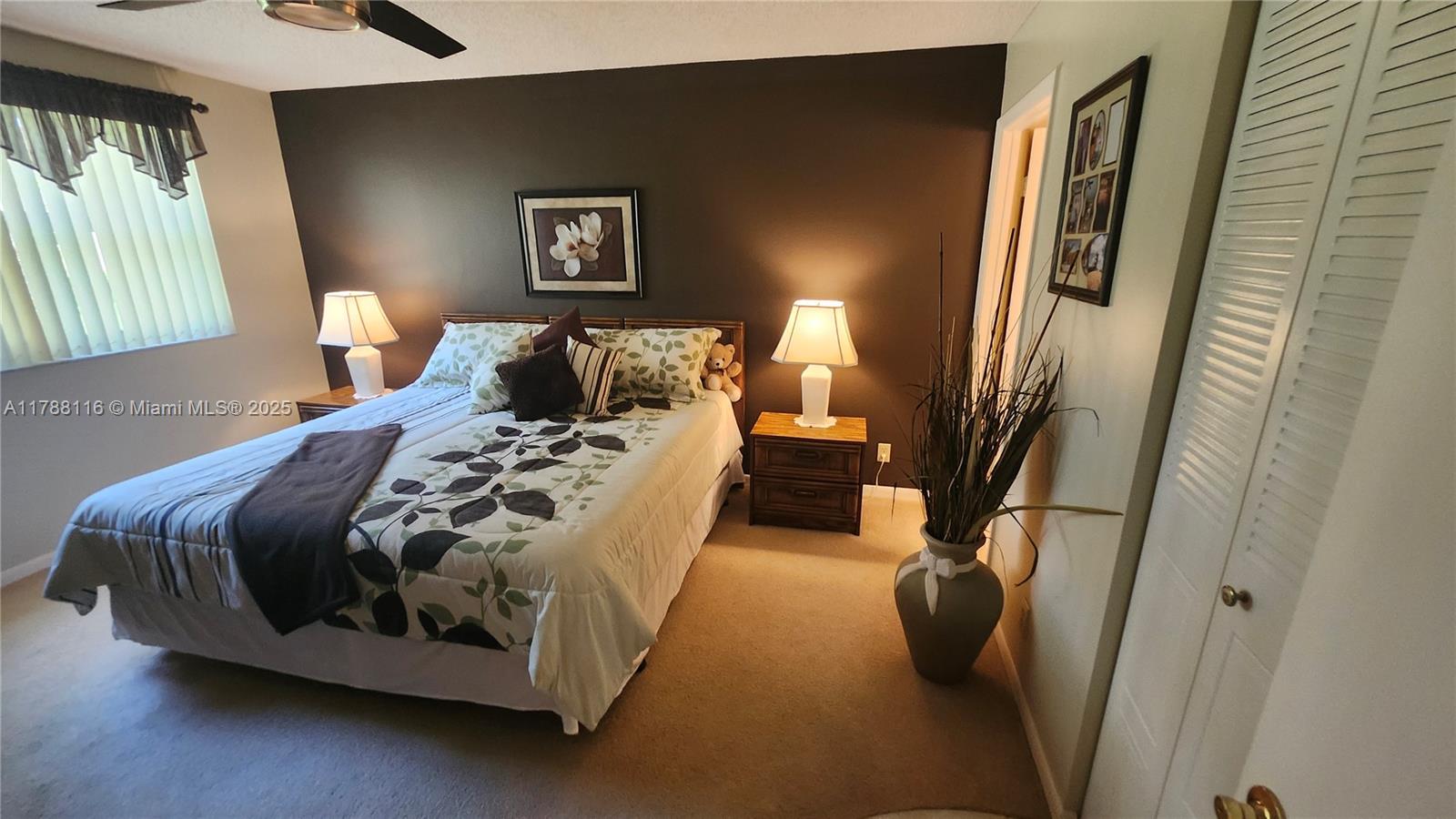 2955 Southwest 22nd Avenue, Unit 1040 Delray Beach, FL 33445 - Photo 4 of 27 a bed sitting in a bedroom next to a window