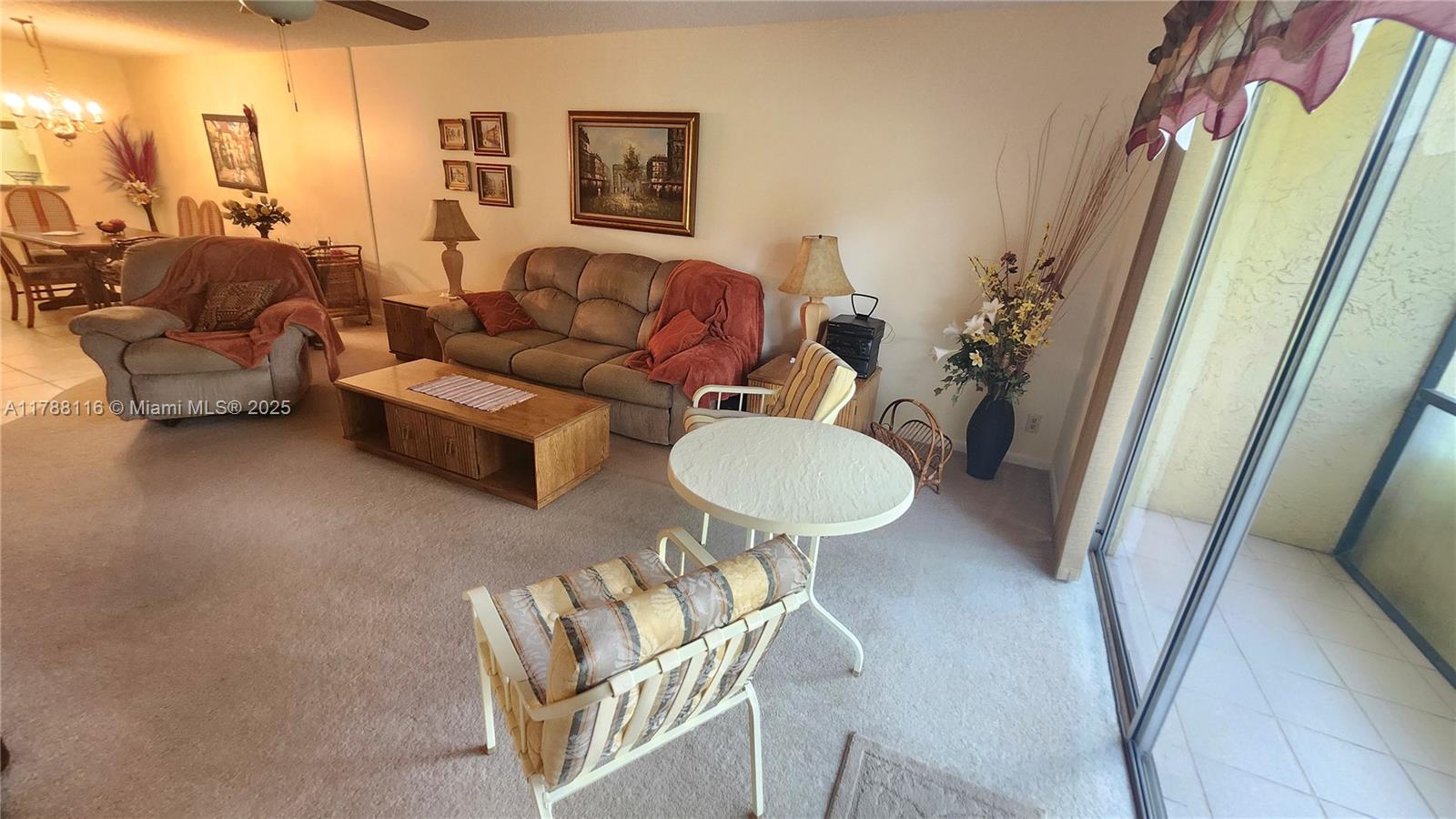 2955 Southwest 22nd Avenue, Unit 1040 Delray Beach, FL 33445 - Photo 5 of 27 a living room with furniture and a table