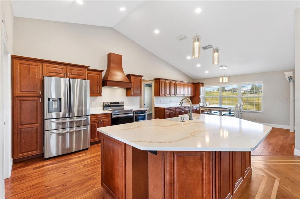 11735 Southeast 174th Loop Summerfield, FL 34491 - Photo 11 of 61 a kitchen with stainless steel appliances granite countertop a refrigerator a sink and a stove