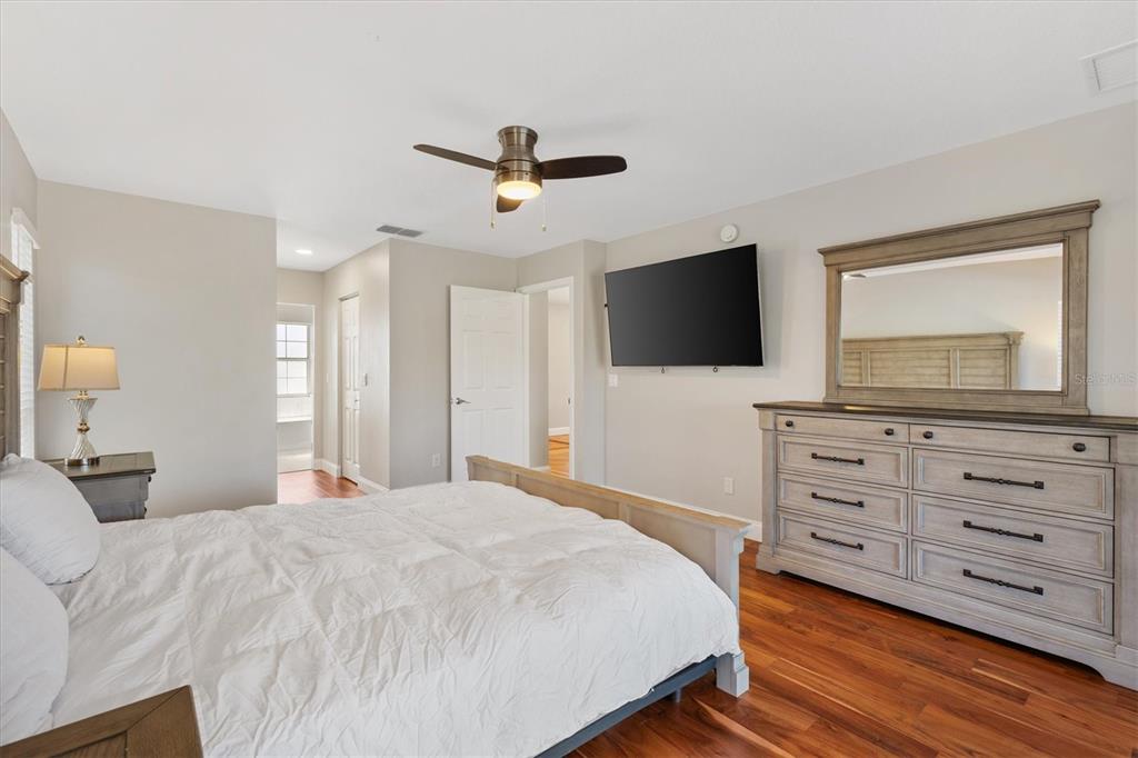 11735 Southeast 174th Loop Summerfield, FL 34491 - Photo 19 of 61 a bedroom with a bed and a flat screen tv