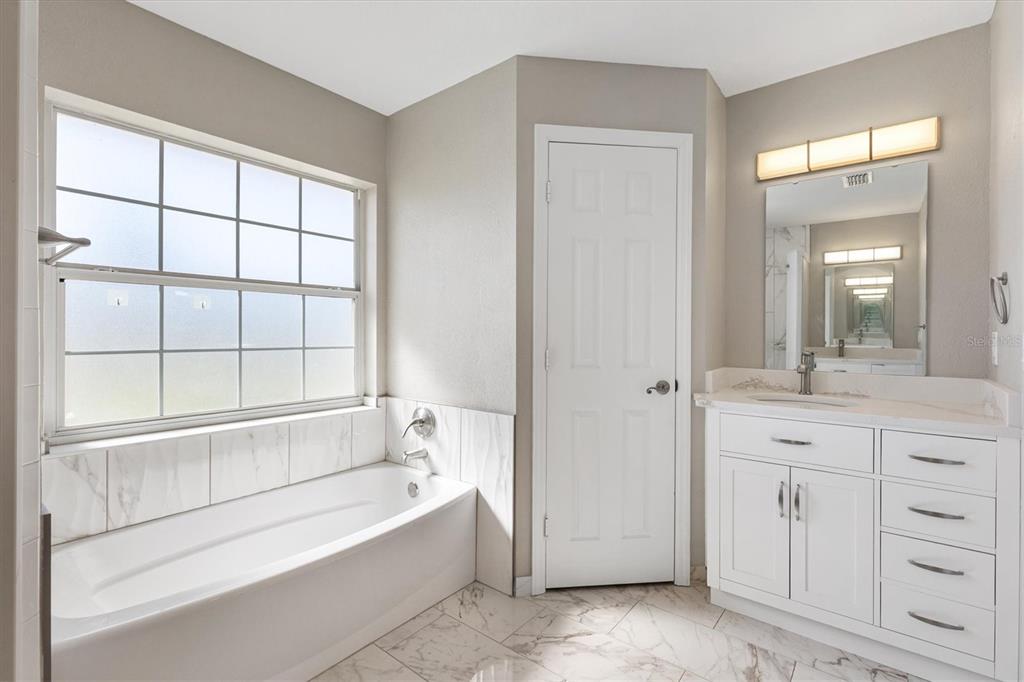 11735 Southeast 174th Loop Summerfield, FL 34491 - Photo 22 of 61 a spacious bathroom with a tub shower and sink