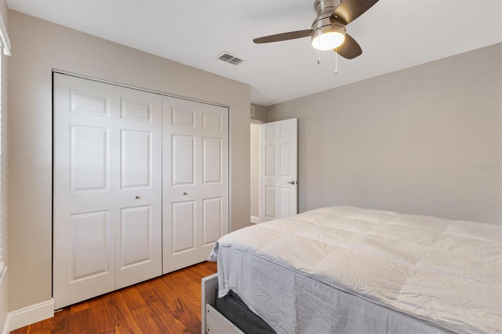 11735 Southeast 174th Loop Summerfield, FL 34491 - Photo 26 of 61 a spacious bedroom with a bed and a chandelier