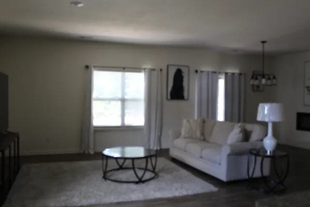 a living room with furniture and a lamp