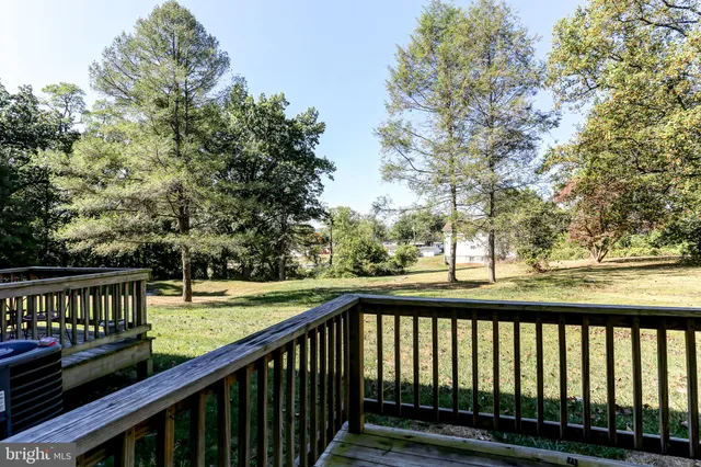 a view of a wooden deck with a yard