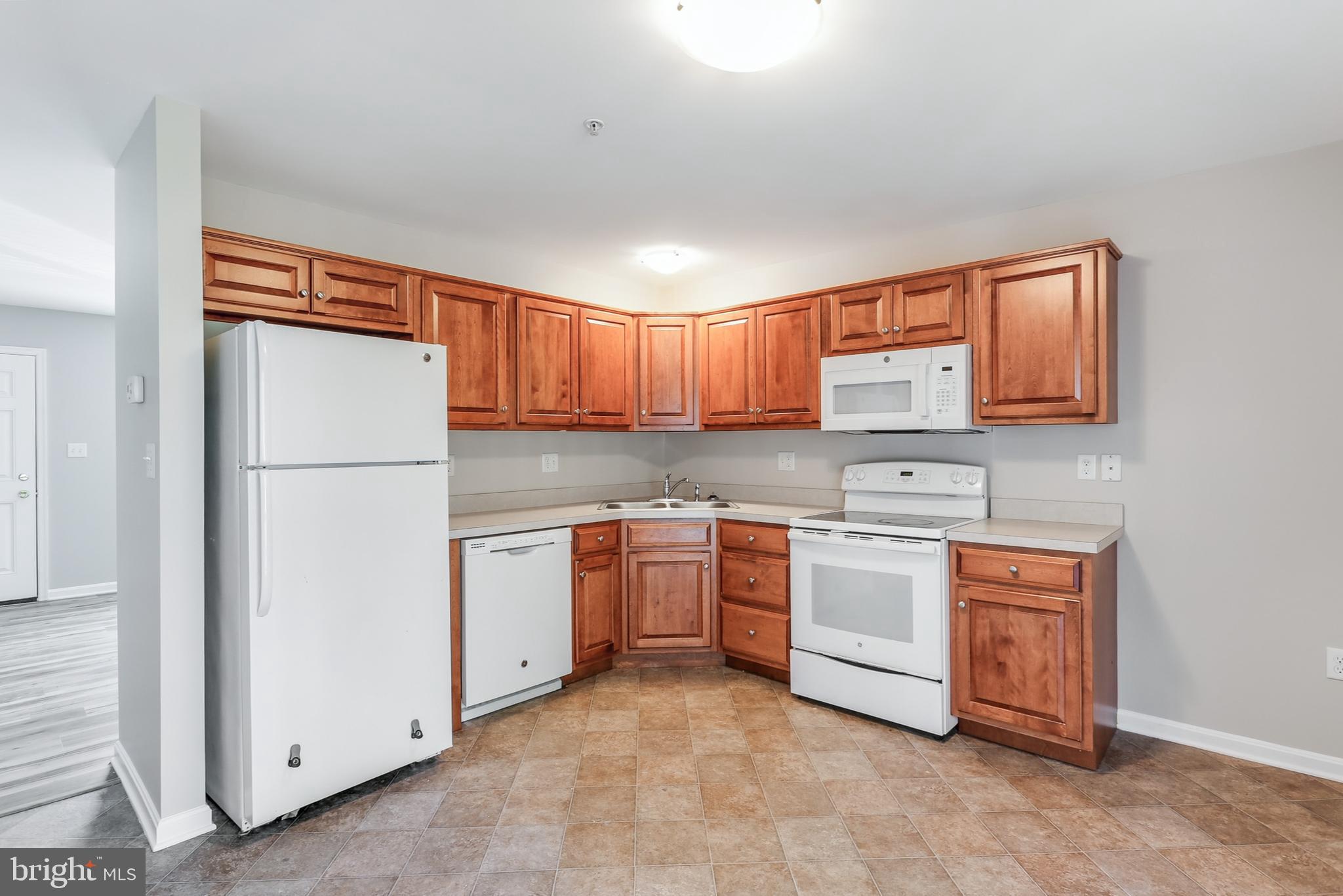 2500 Mill Road, Unit 7 Mechanicsburg, PA 17055 - Photo 4 of 11 a kitchen with stainless steel appliances granite countertop a refrigerator sink and stove