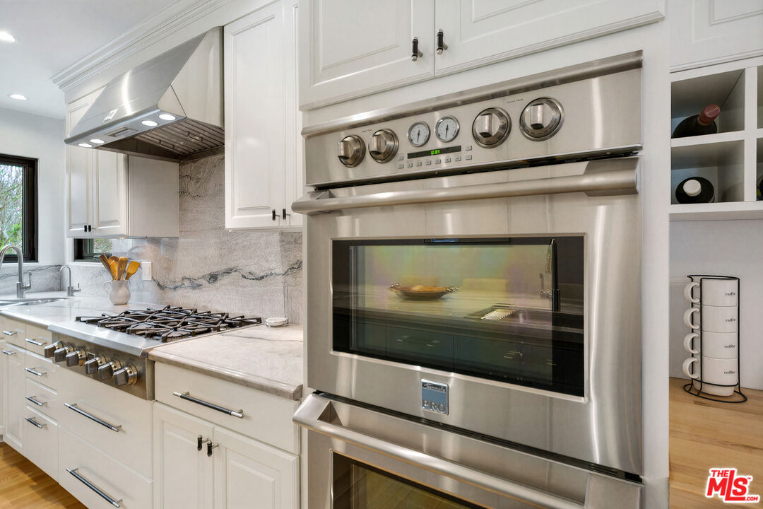 3558 Muirfield Road South Los Angeles, CA 90016 - Photo 11 of 35 a stove top oven sitting inside of a kitchen