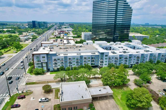 a view of building with yard and outdoor seating
