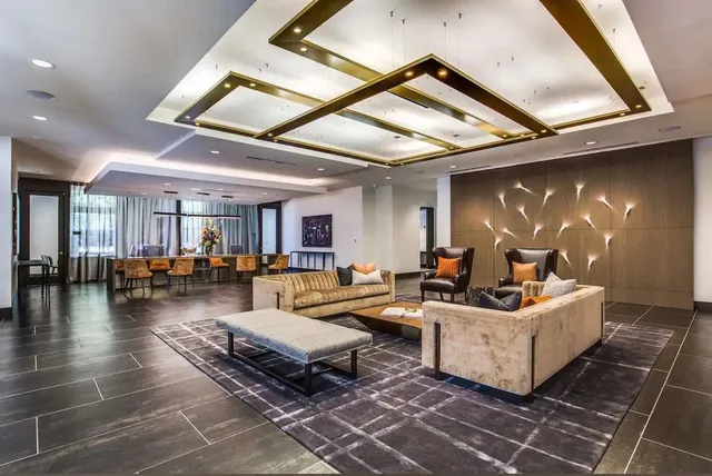 a living room with furniture and a chandelier