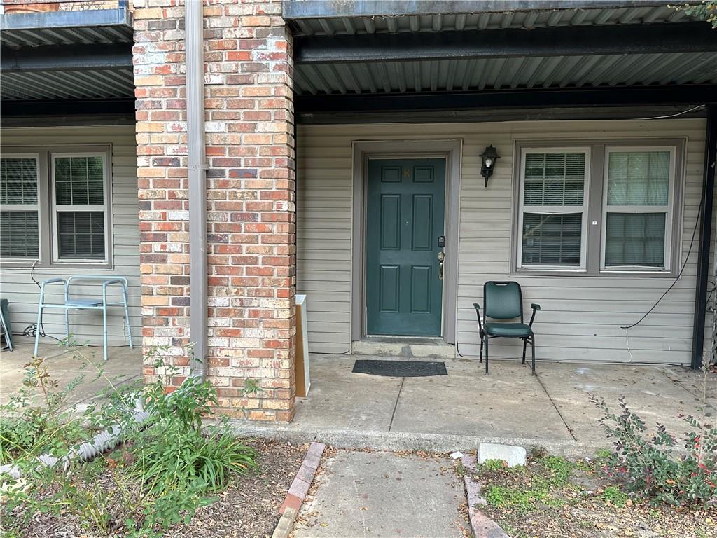a front view of a house with a yard and glass windows