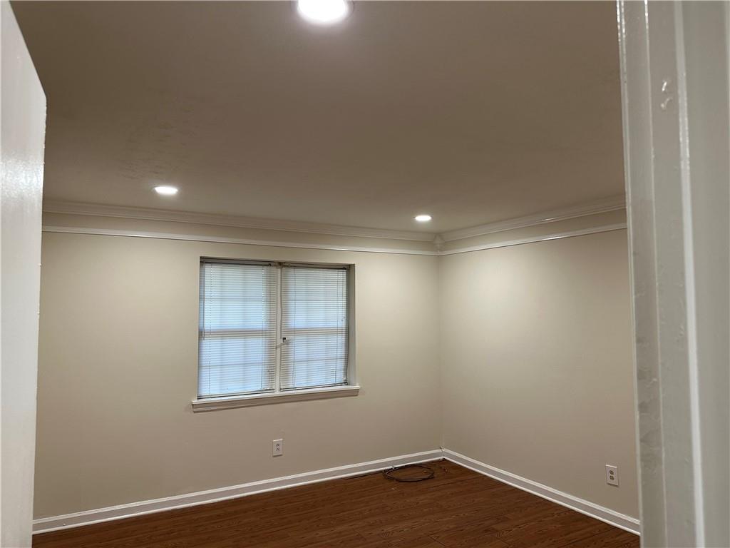 3071 Colonial Way, Unit K Atlanta, GA 30341 - Photo 17 of 20 an empty room with wooden floor and windows