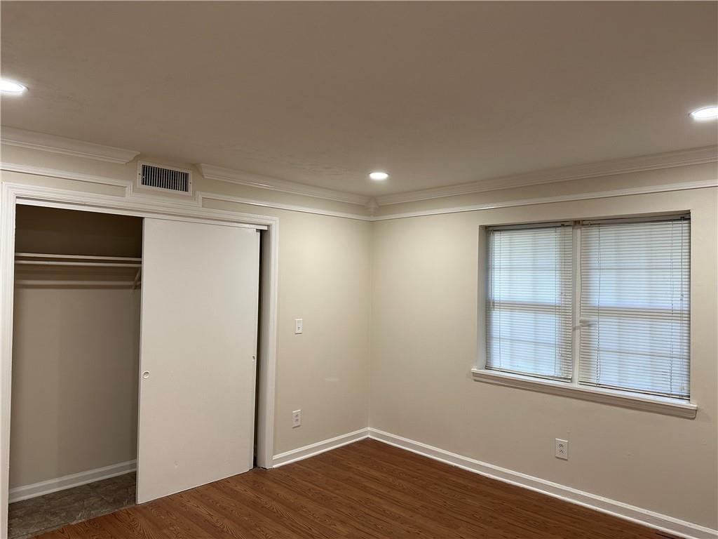 3071 Colonial Way, Unit K Atlanta, GA 30341 - Photo 18 of 20 a view of an empty room with a window and wooden floor
