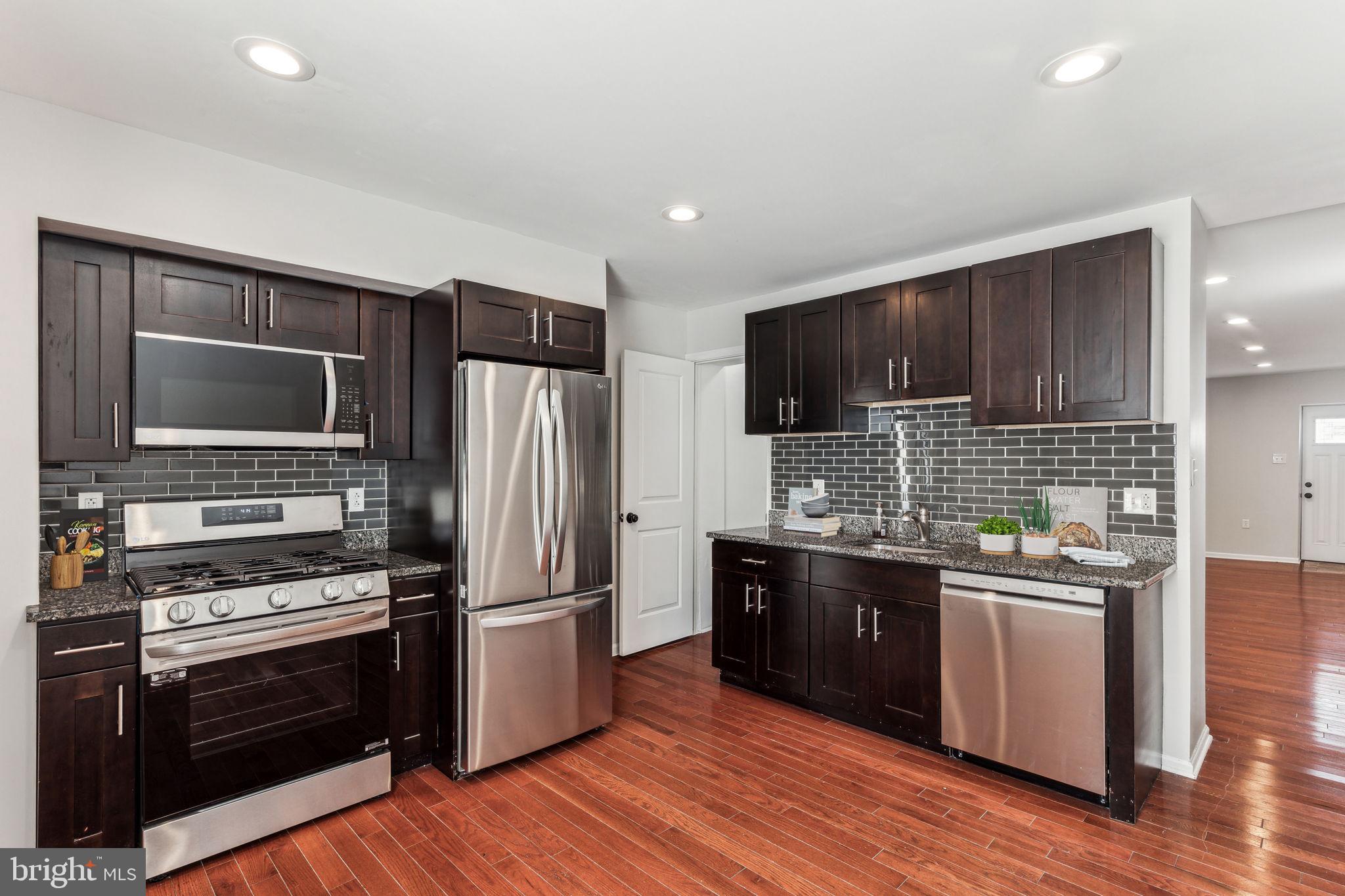 3131 Edgemont Street Philadelphia, PA 19134 - Photo 14 of 39 a kitchen with stainless steel appliances a stove a sink and a microwave