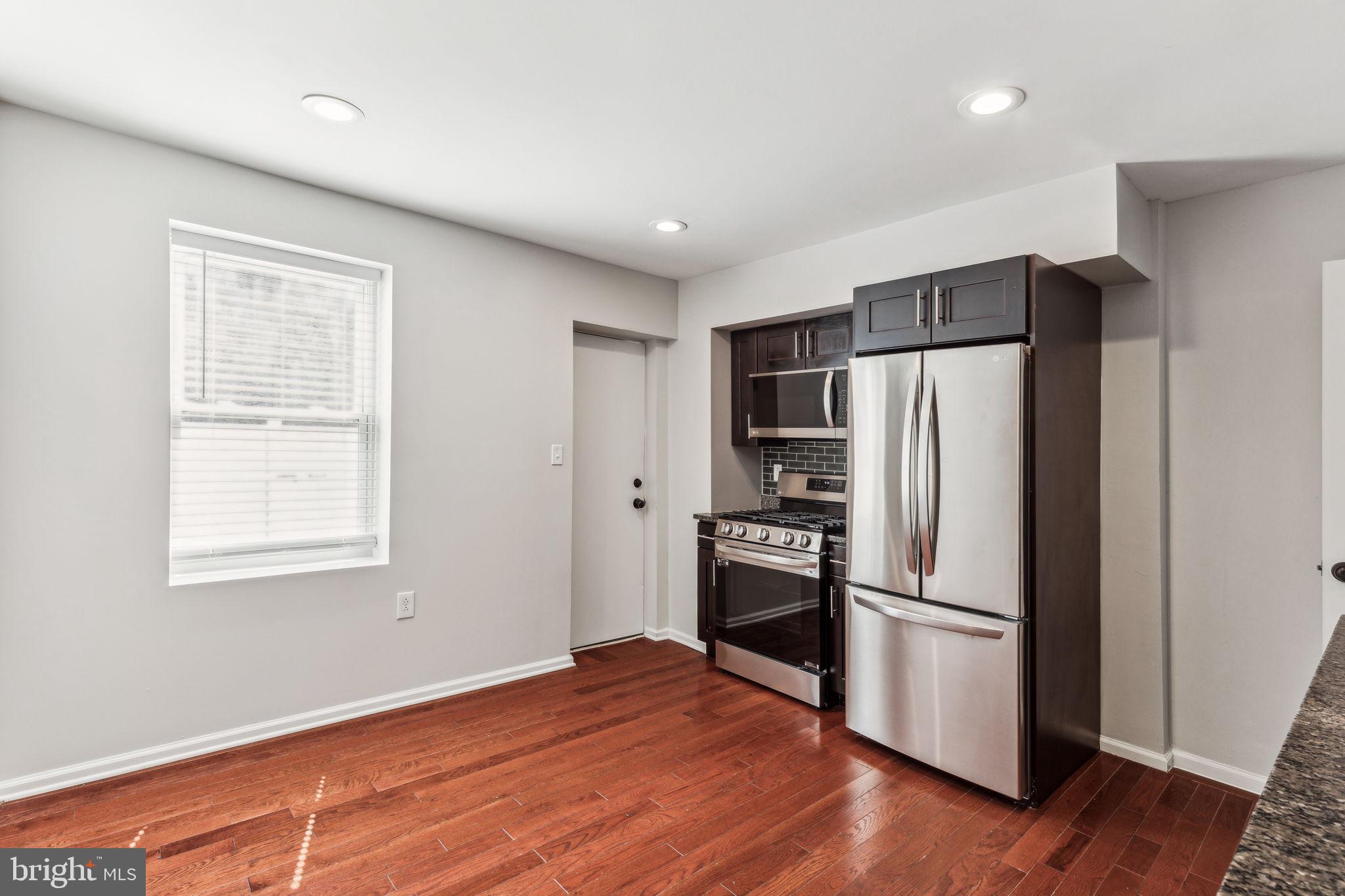 3131 Edgemont Street Philadelphia, PA 19134 - Photo 15 of 39 a kitchen with stainless steel appliances a refrigerator and wooden floor
