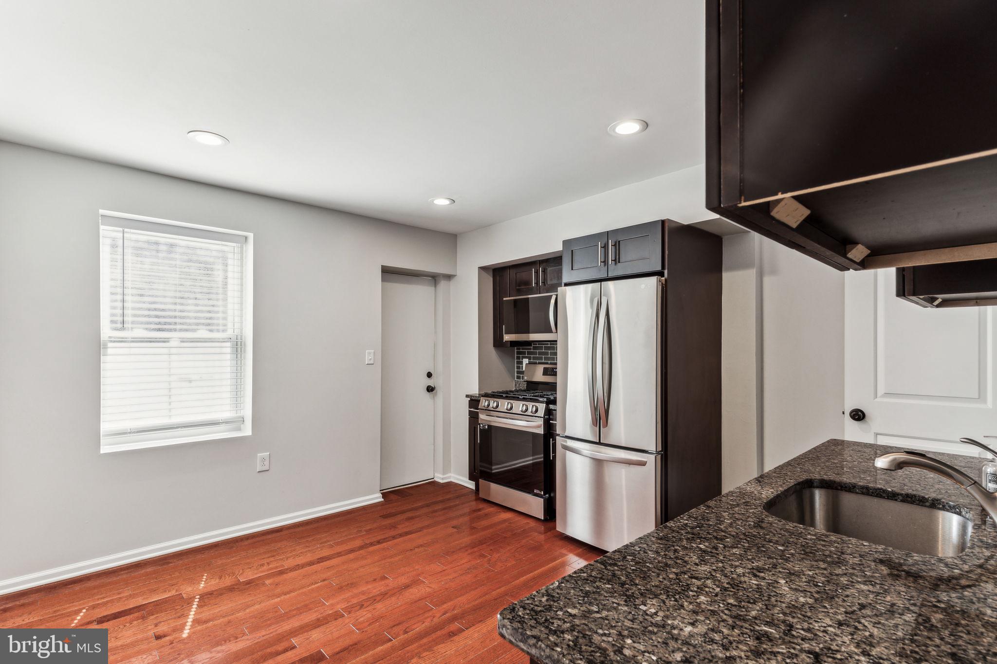 3131 Edgemont Street Philadelphia, PA 19134 - Photo 16 of 39 a kitchen with stainless steel appliances granite countertop a refrigerator sink and stove