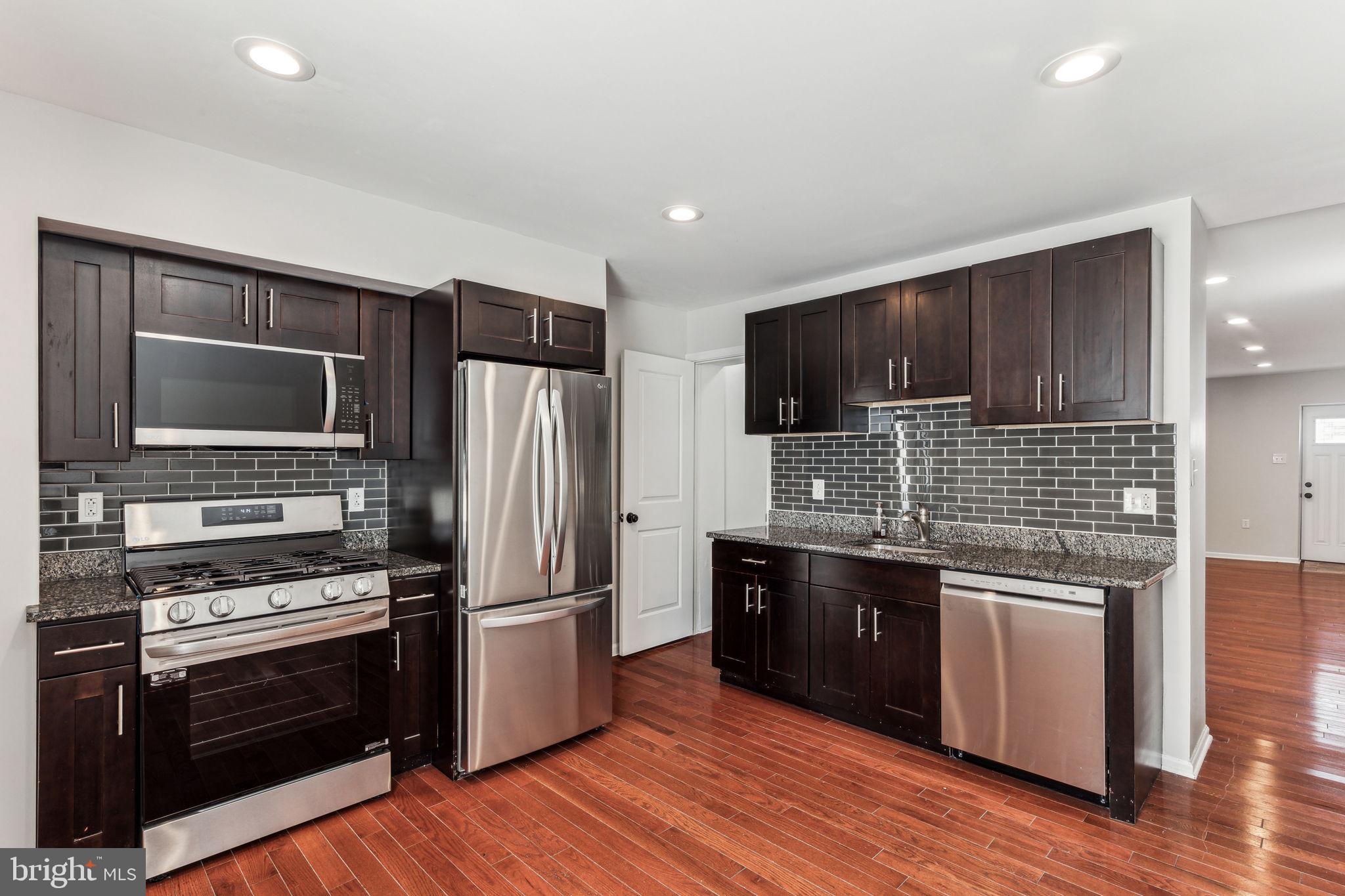 3131 Edgemont Street Philadelphia, PA 19134 - Photo 17 of 39 a kitchen with stainless steel appliances a stove a sink and a microwave