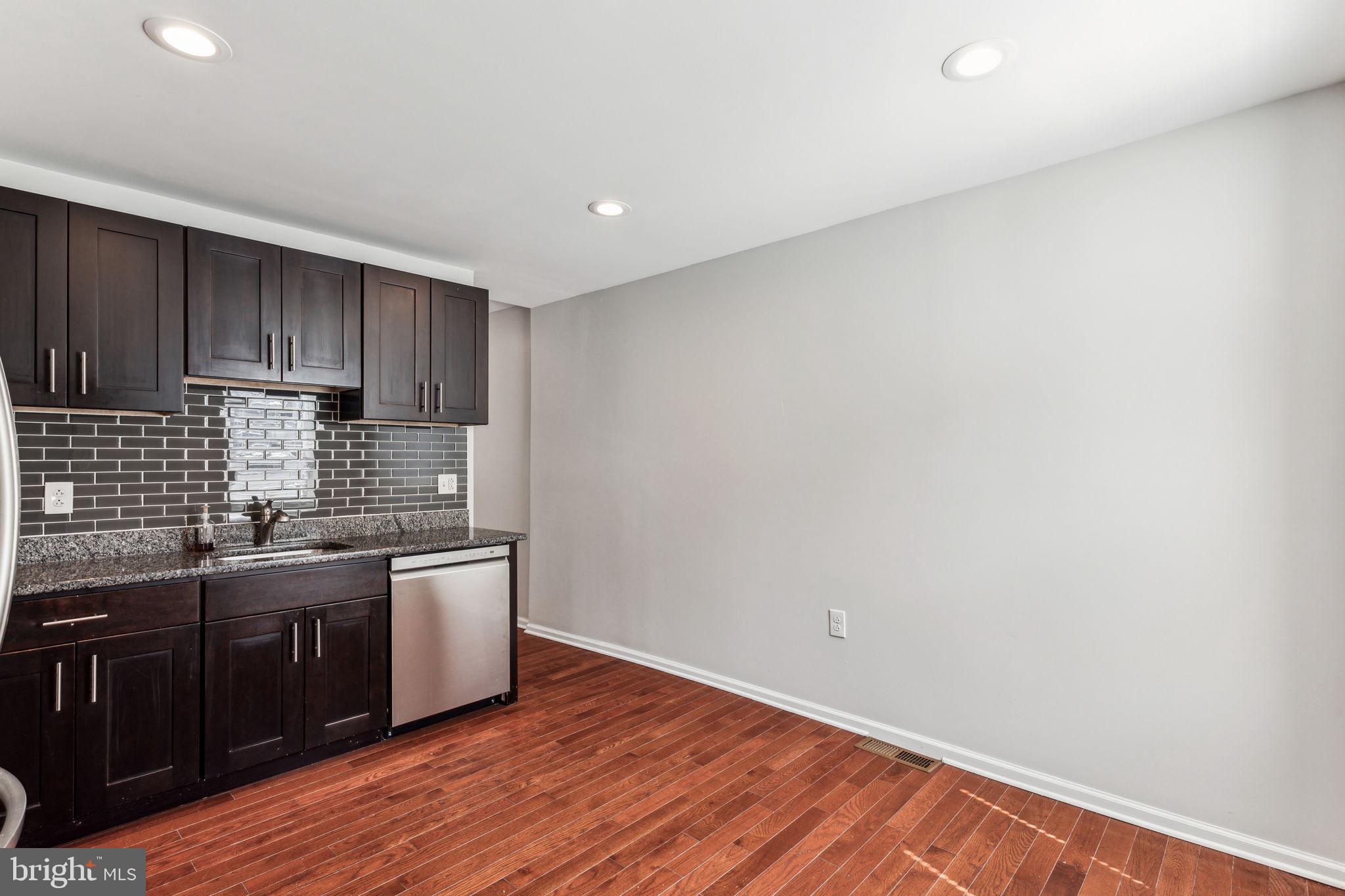 3131 Edgemont Street Philadelphia, PA 19134 - Photo 18 of 39 a kitchen with stainless steel appliances granite countertop a sink a stove a refrigerator and cabinets