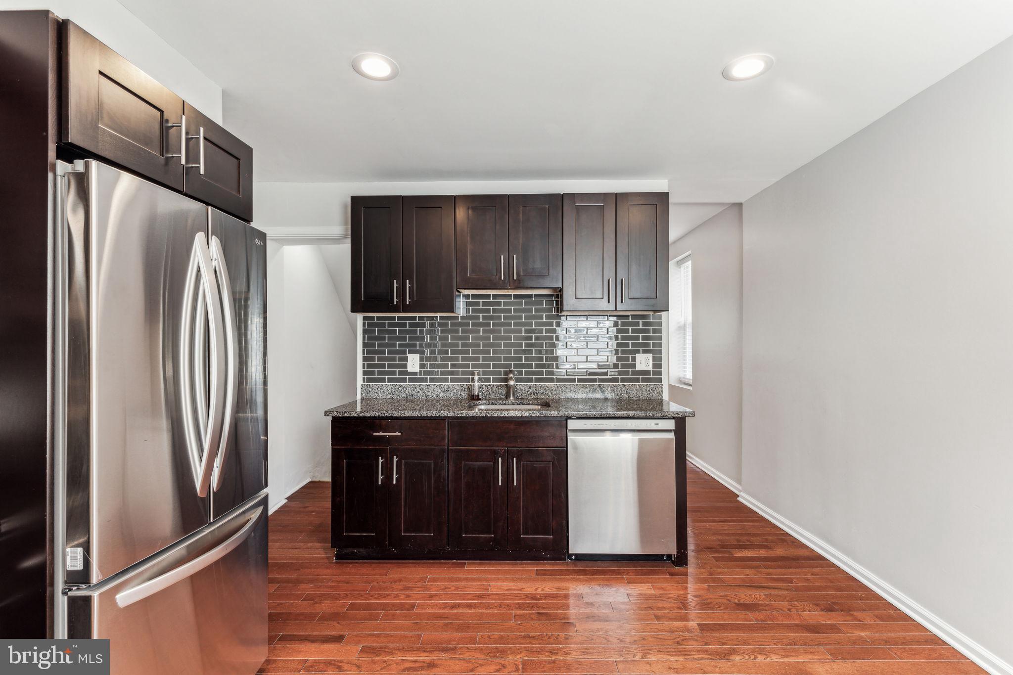 3131 Edgemont Street Philadelphia, PA 19134 - Photo 19 of 39 a kitchen with stainless steel appliances granite countertop a refrigerator and a stove
