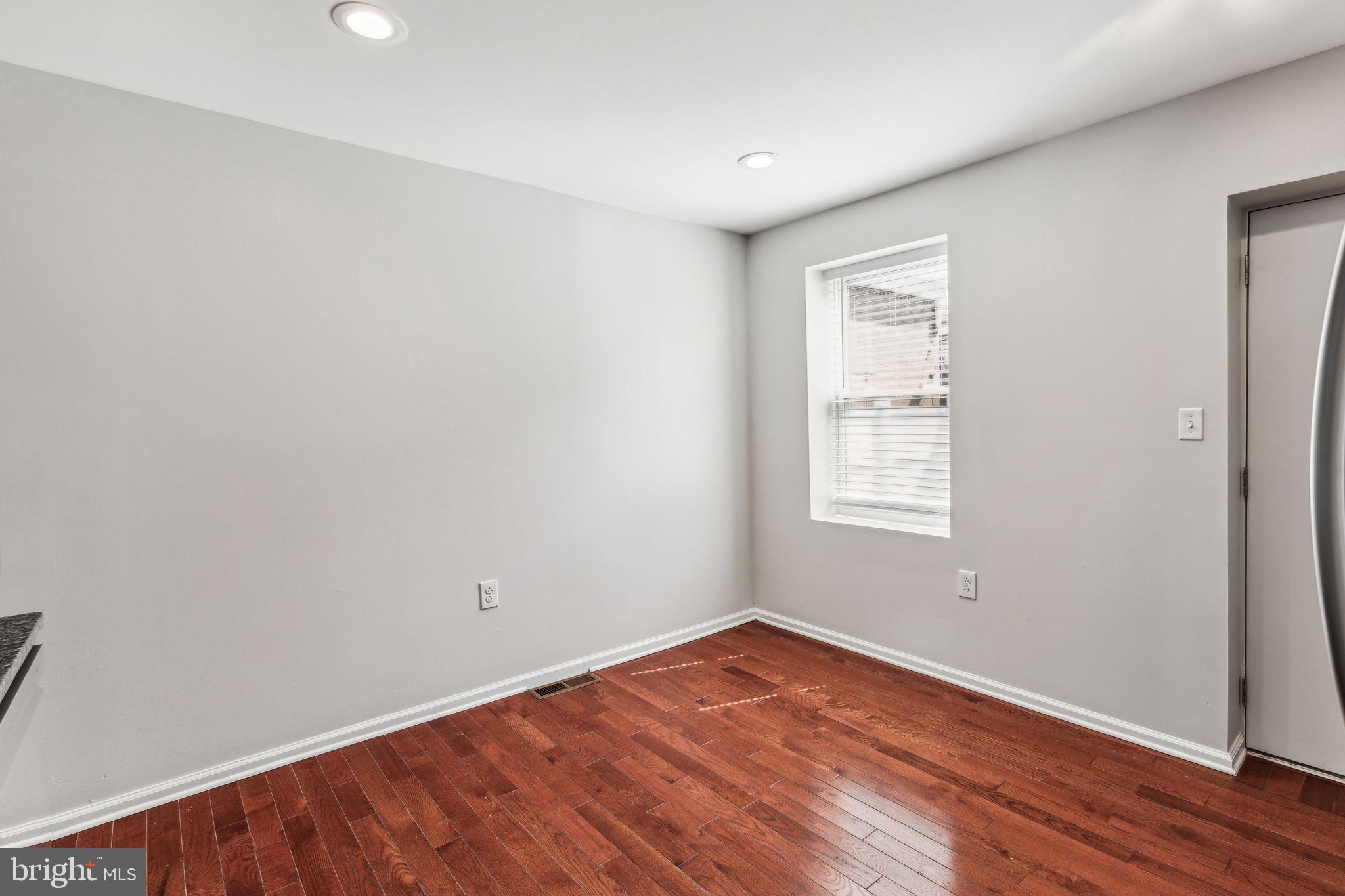3131 Edgemont Street Philadelphia, PA 19134 - Photo 32 of 39 an empty room with wooden floor and windows