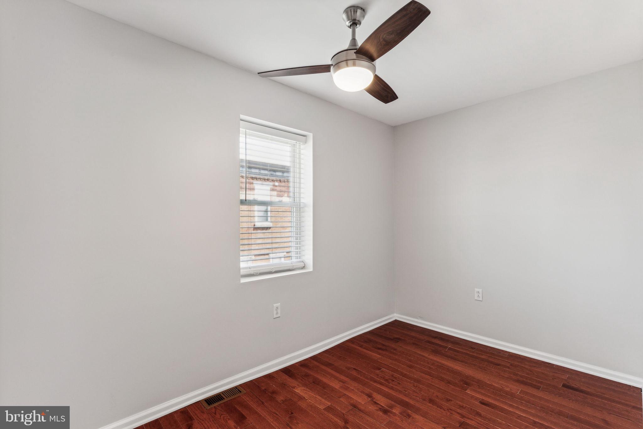 3131 Edgemont Street Philadelphia, PA 19134 - Photo 35 of 39 an empty room with a window and a ceiling fan