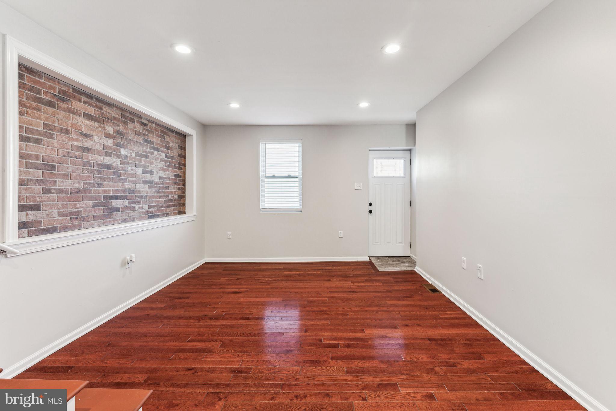 3131 Edgemont Street Philadelphia, PA 19134 - Photo 10 of 39 an empty room with wooden floor and windows