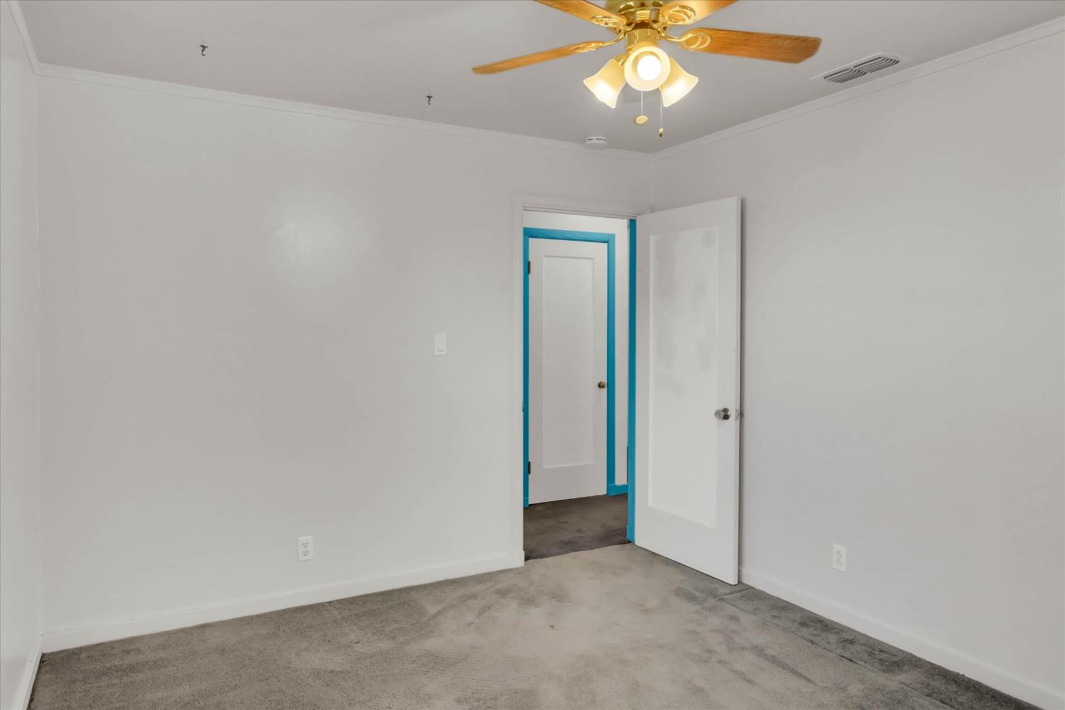 39640 South River Road Clarksburg, CA 95612 - Photo 19 of 25 an empty room with a chandelier fan and windows