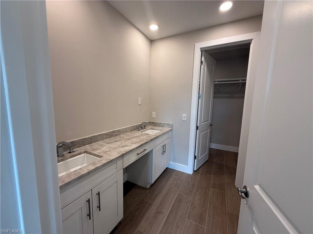8909 Oceana Way Naples, FL 34114 - Photo 17 of 41 an empty room with wooden floor and entrance