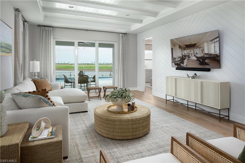 8909 Oceana Way Naples, FL 34114 - Photo 2 of 41 a living room with furniture and a large window