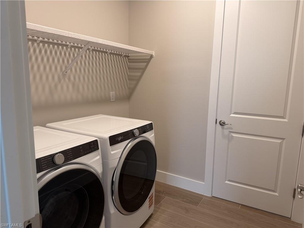 8909 Oceana Way Naples, FL 34114 - Photo 21 of 41 a utility room with dryer and washer