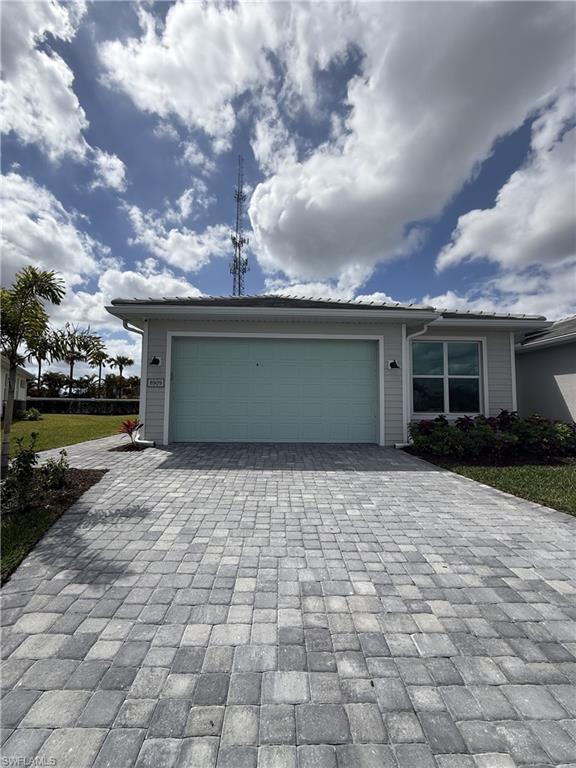 8909 Oceana Way Naples, FL 34114 - Photo 22 of 41 a front view of a house with a yard and potted plants