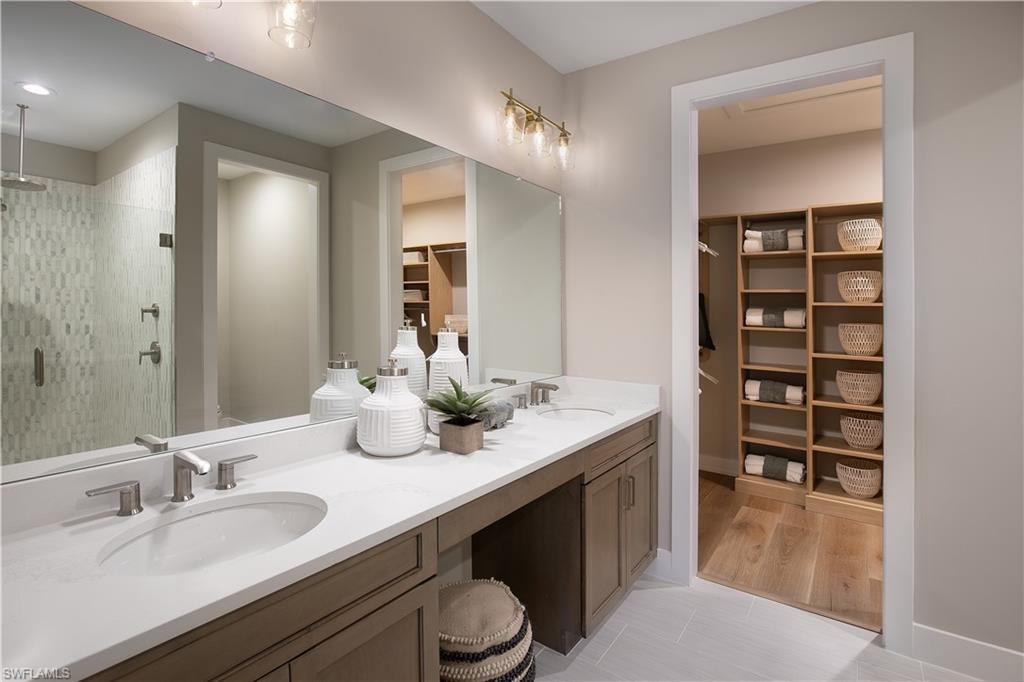 8909 Oceana Way Naples, FL 34114 - Photo 5 of 41 a bathroom with a granite countertop sink and a mirror
